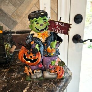 Frankenstein with pumpkin metal luminary Halloween decor.